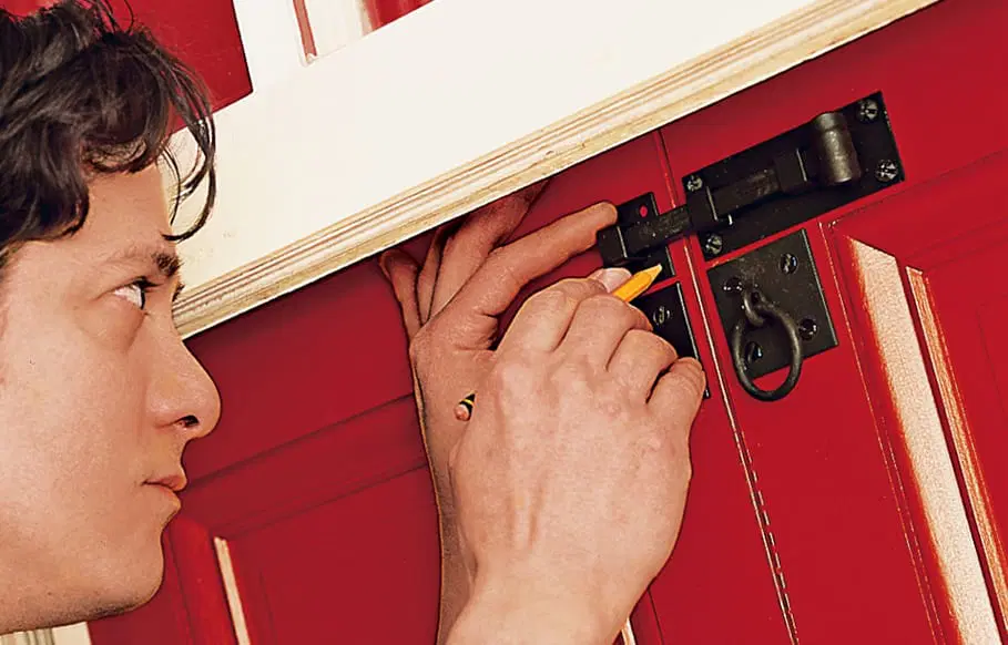 attaching the locks for the shutters to keep them closed