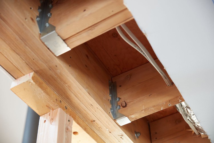 Wooden joists supporting ceiling