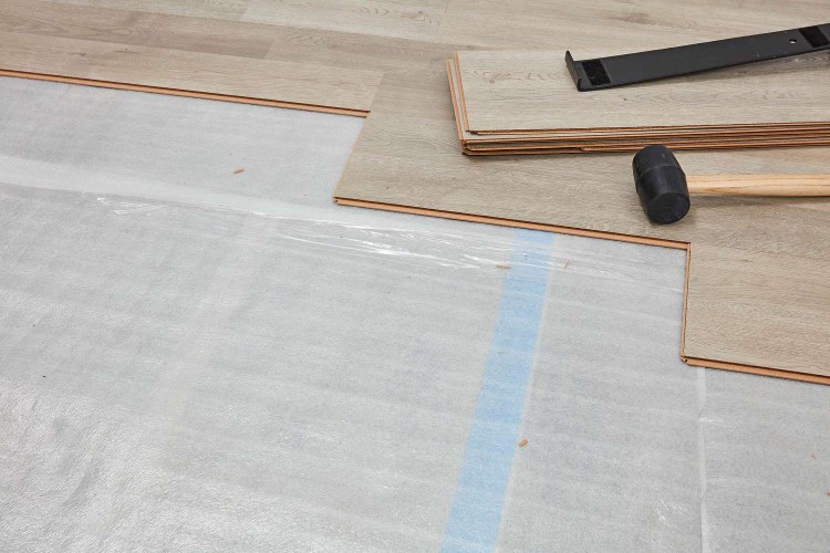 Underlayment exposed with planks being installed