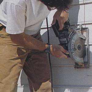using a saw to cut a wall in preparation for the installation of a french door