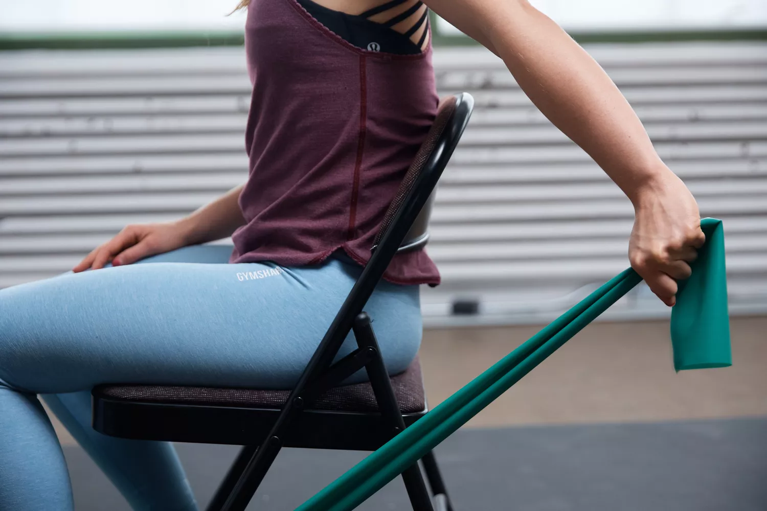 Person seated in chair using Healthy Seniors Chair Exercise Program with Two Resistance Bands