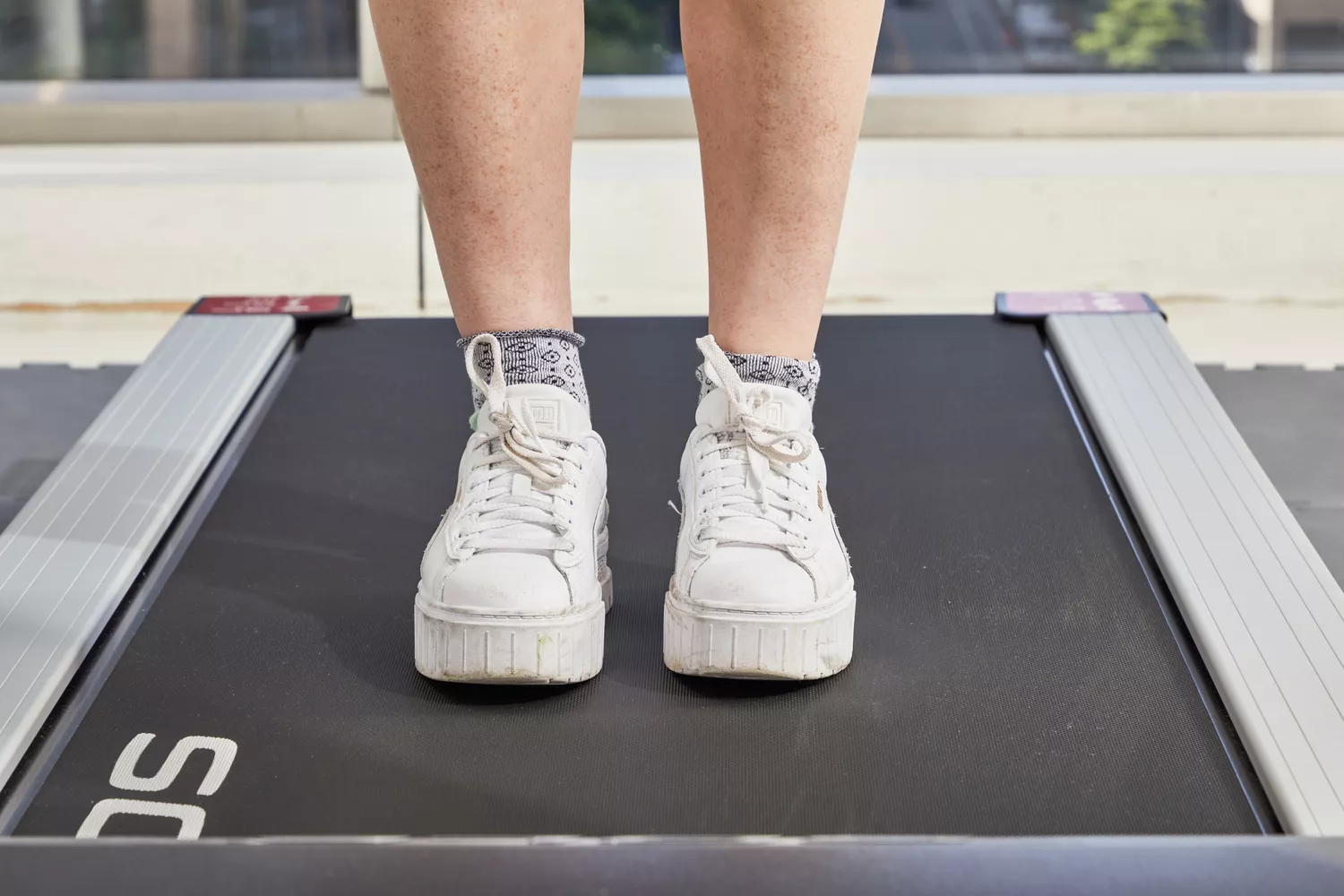 Feet standing on a treadmill