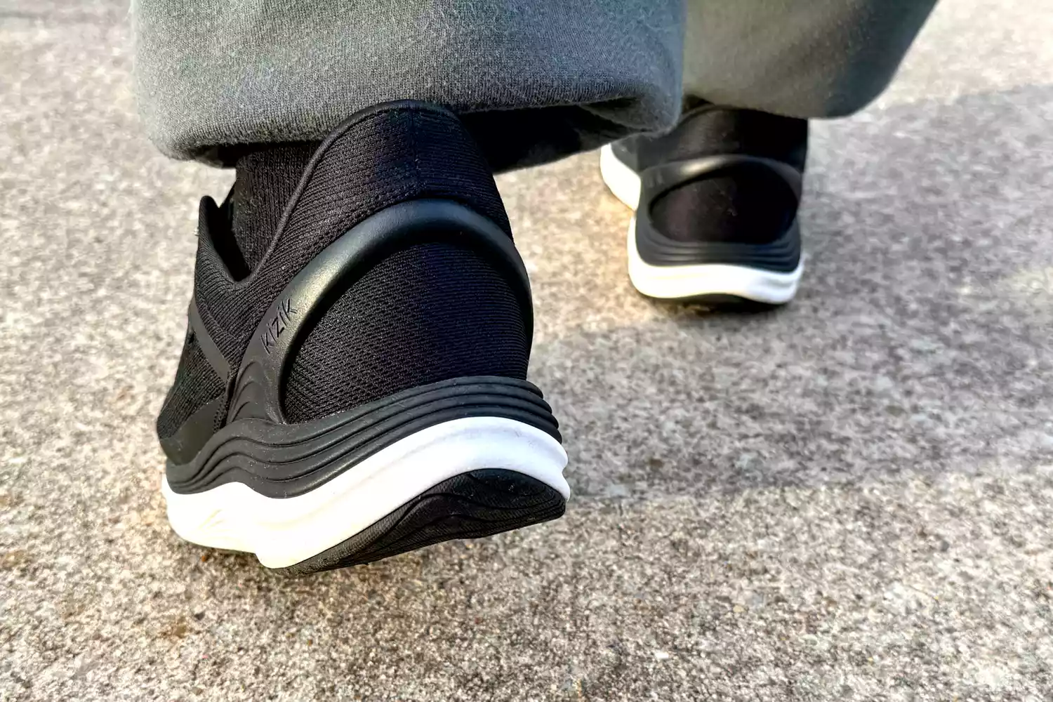 A close-up of the Kizik Men's London Sneakers worn on concrete