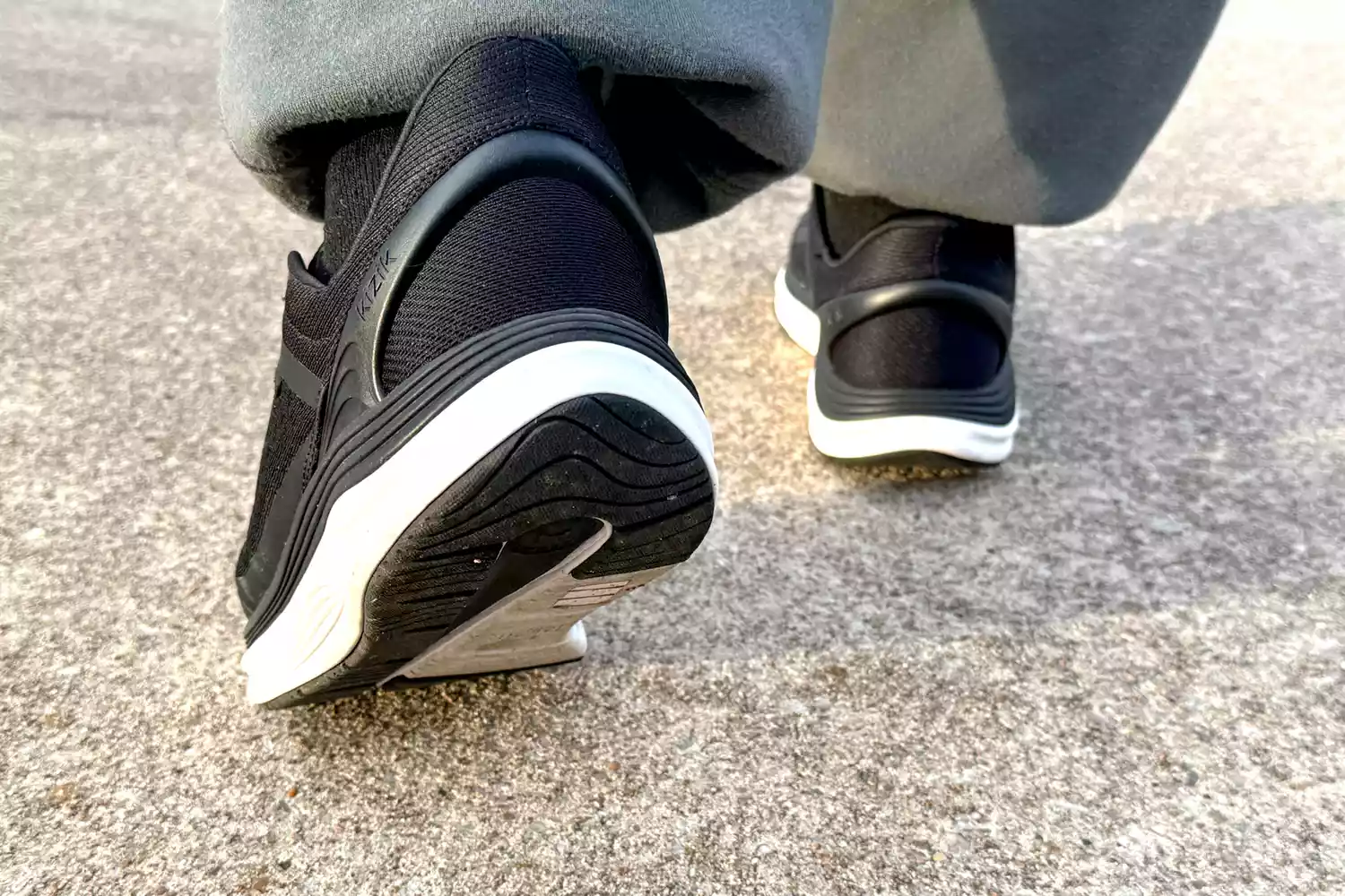 The back of a person walking while wearing the Kizik Men's London Sneakers