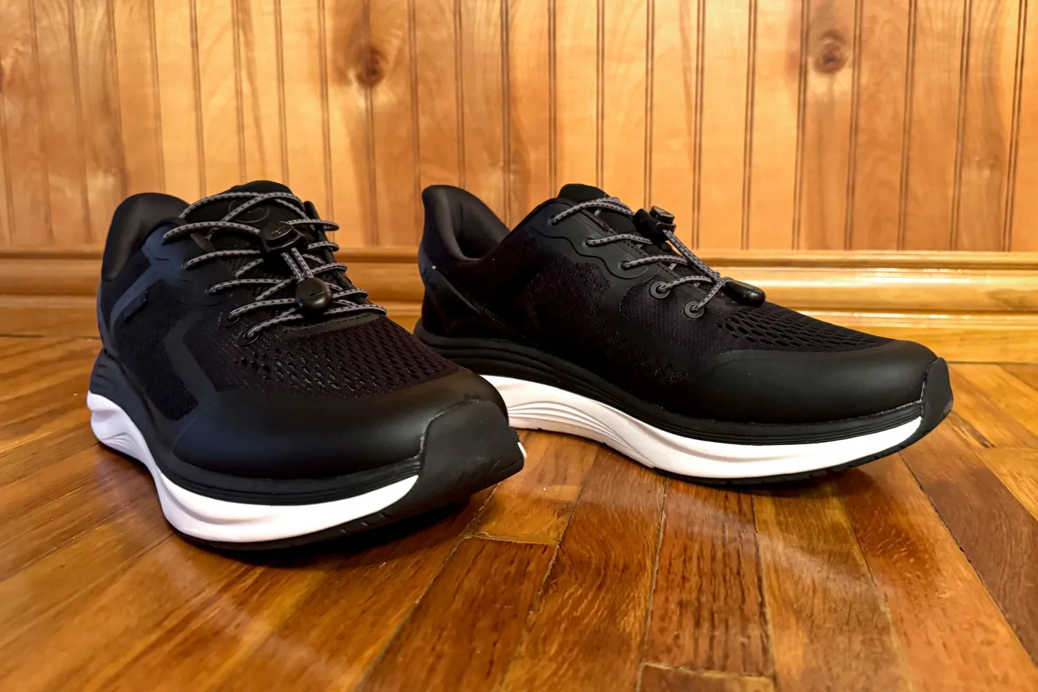 The Kizik Men's London Sneakers posed on wood