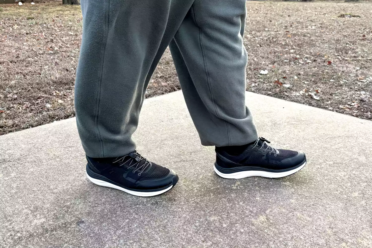 The Kizik Men's London Sneakers worn on concrete