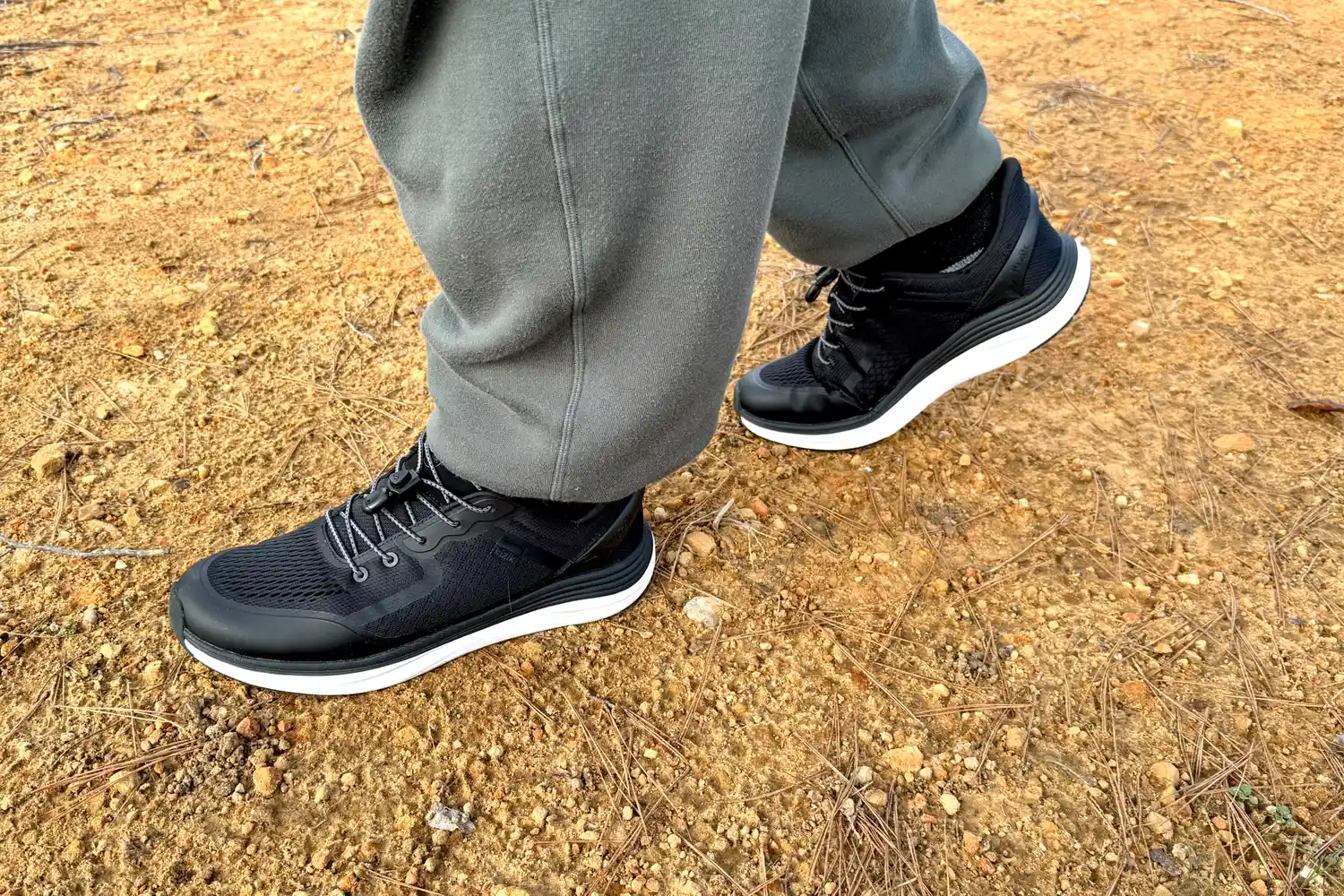 A close-up of a person's feet while walking in the Kizik Men's London Sneakers