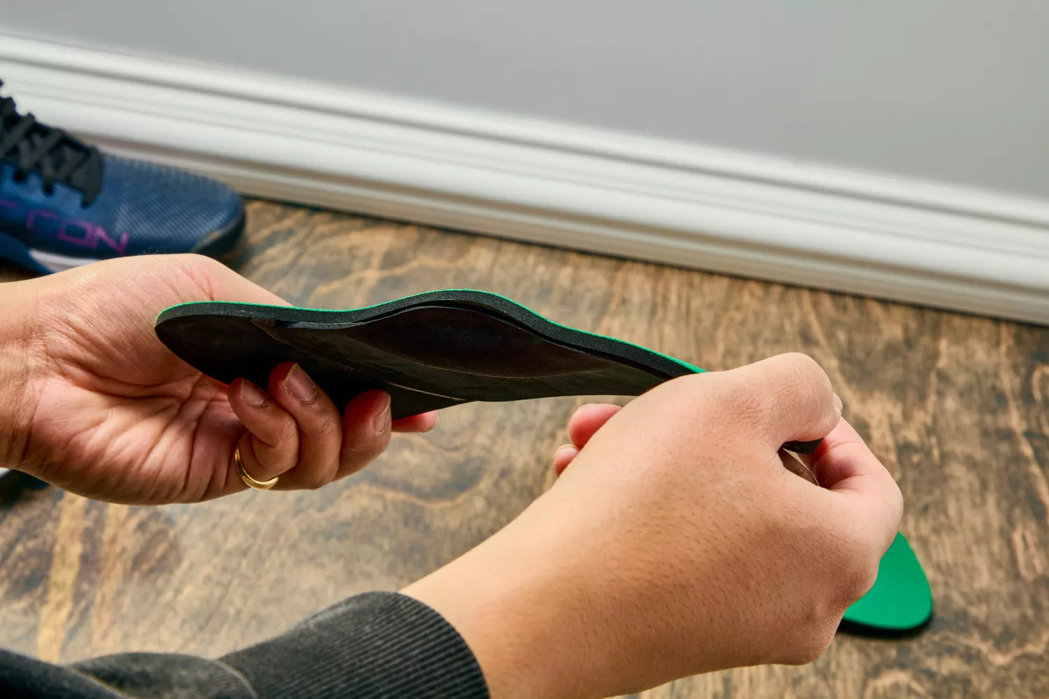 Hands holding a Spenco RX Comfort Insole