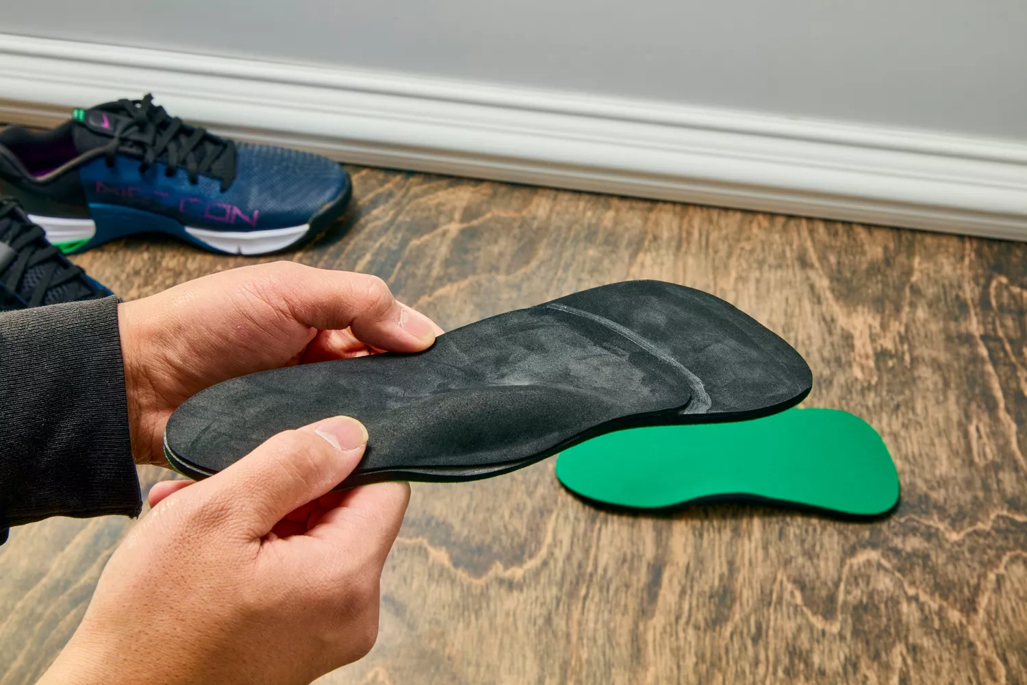 Hands holding a Spenco RX Comfort Insole