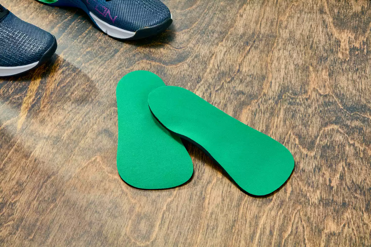 Spenco RX Comfort Insoles displayed on a wood floor