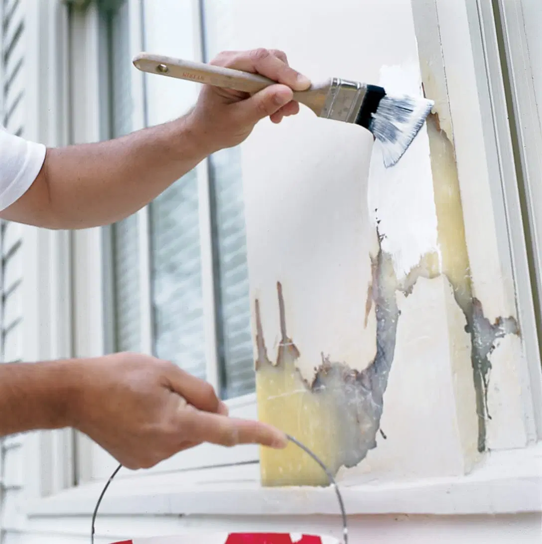 Using a paintbrush to paint on epoxy.