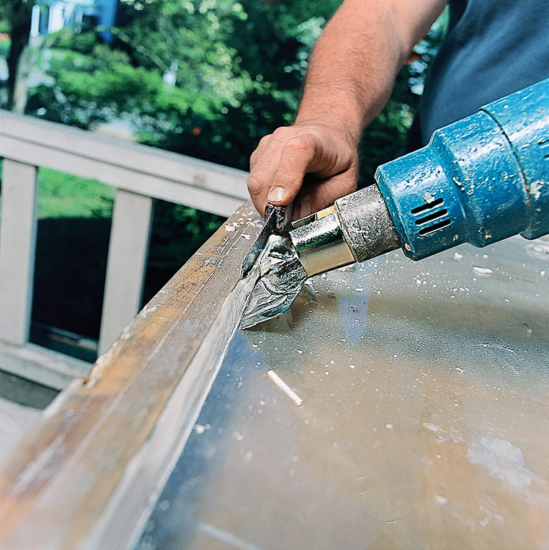 A man performing a repair on a glass window.