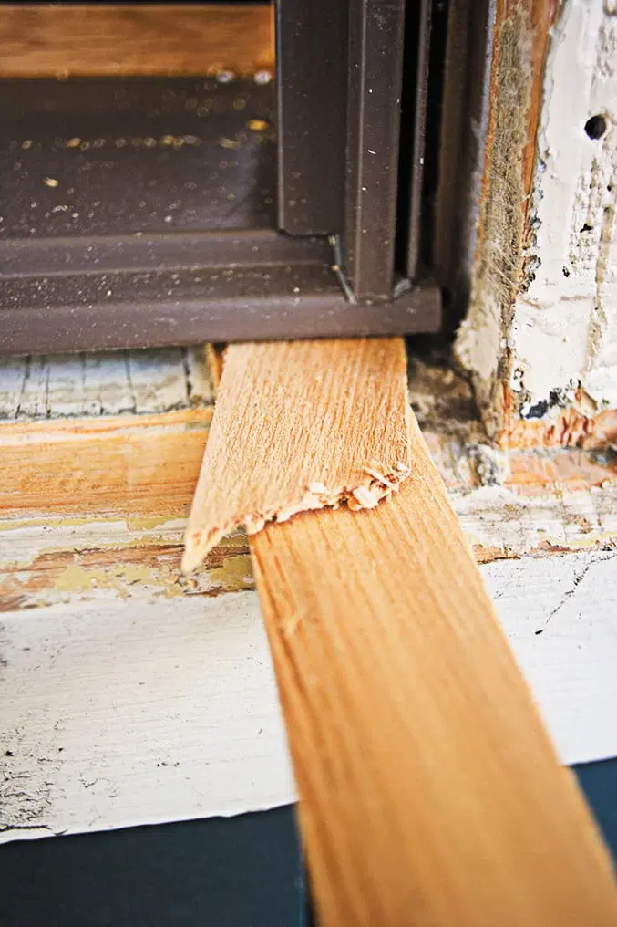 Shims sit underneath the replacement window.