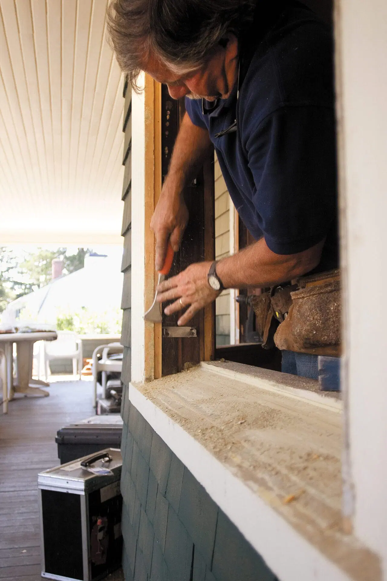 Tom Silva preps the frames for replacement windows.