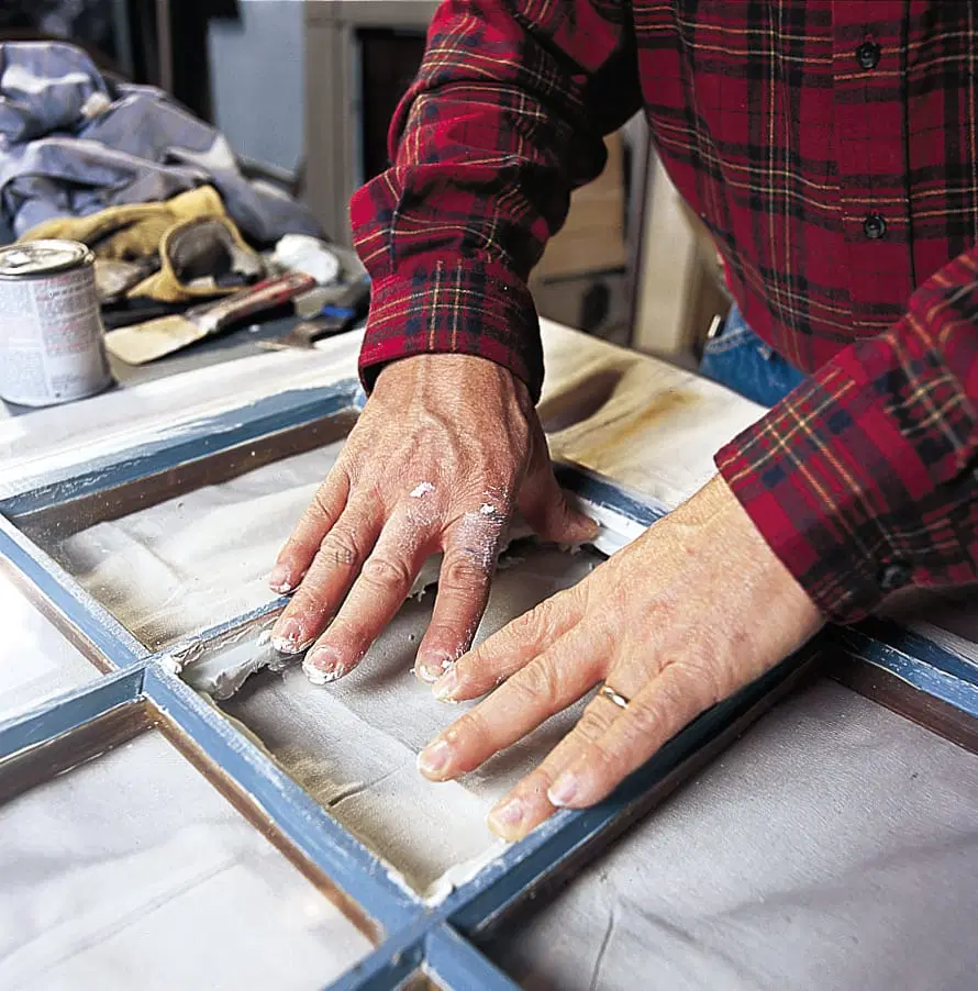 New glass being placed into a window pane.