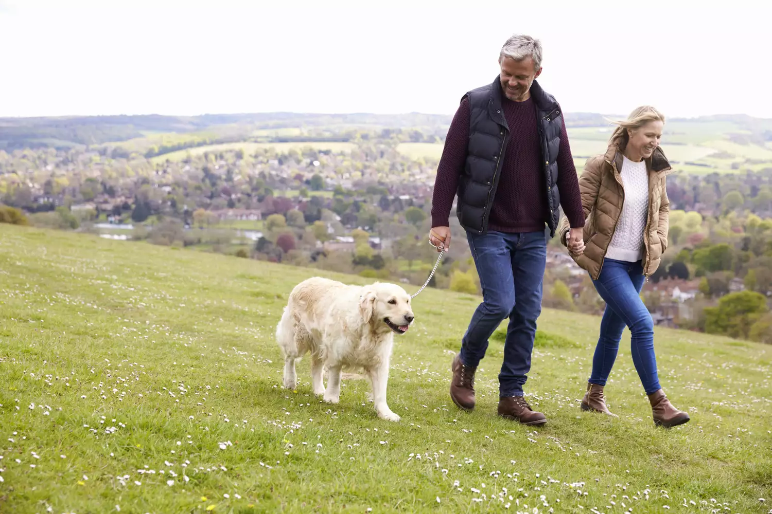 mature couple walking with dog