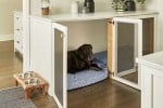 black Lab in crate built under kitchen cabinet