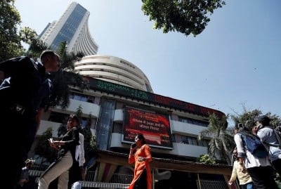 &copy; Reuters. FILE PHOTO: People walk past the Bombay Stock Exchange (BSE) building in Mumbai, India, March 9, 2020. REUTERS/Francis Mascarenhas/File Photo