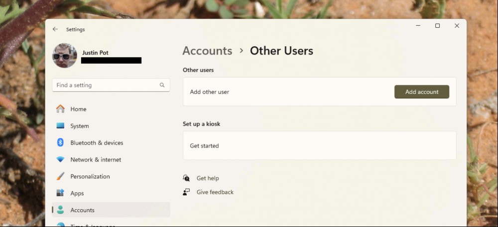 The Windows Settings app showing the "Add User" button.