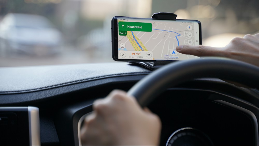 A person using Google Maps while driving