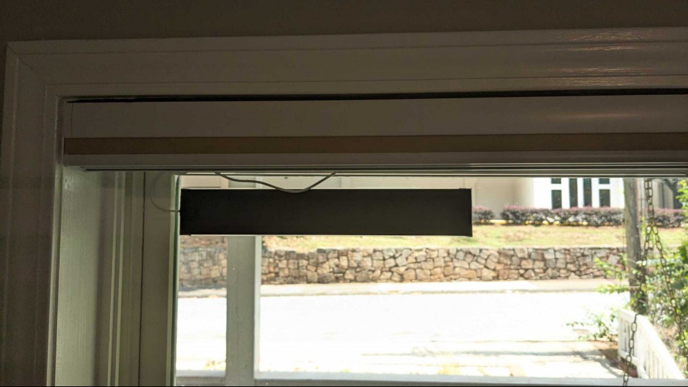 The solar panel glues on the window right under the blind.