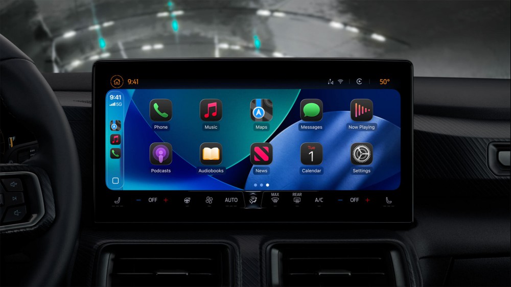 A car head unit showing the new Liquid Glass icons in dark mode.