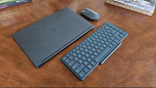 The Lenovo Yoga Book 9i with the lid closed alongside the Bluetooth keyboard and mouse.