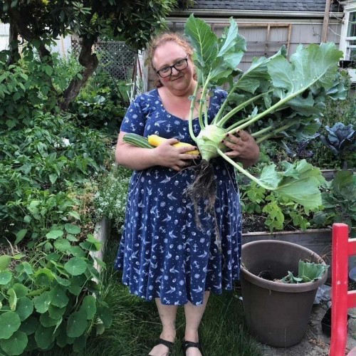 Image of insane garden lady holding an obscenely large kohlrabi. 