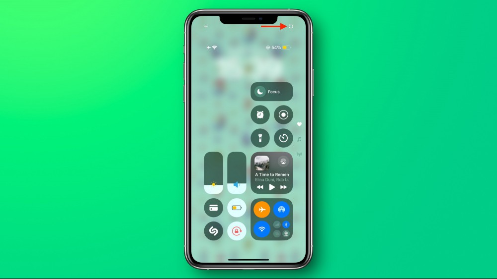 The iOS 18 Control Center with the power button marked with an arrow.