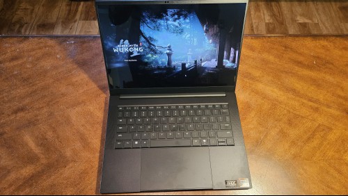 Razer Blade 14 laptop open on a table, displaying Black Myth Wukong.