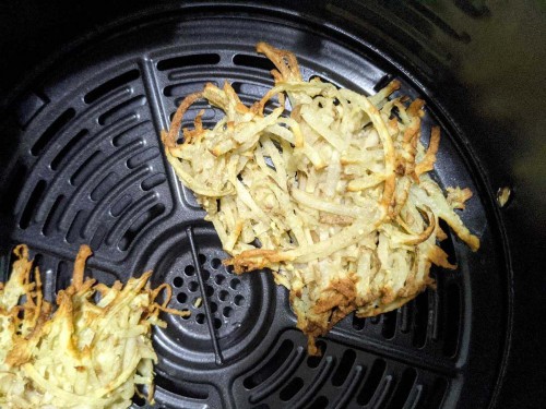 sad looking, dried and weirdly colored, falling apart latkes in an air fryer. 