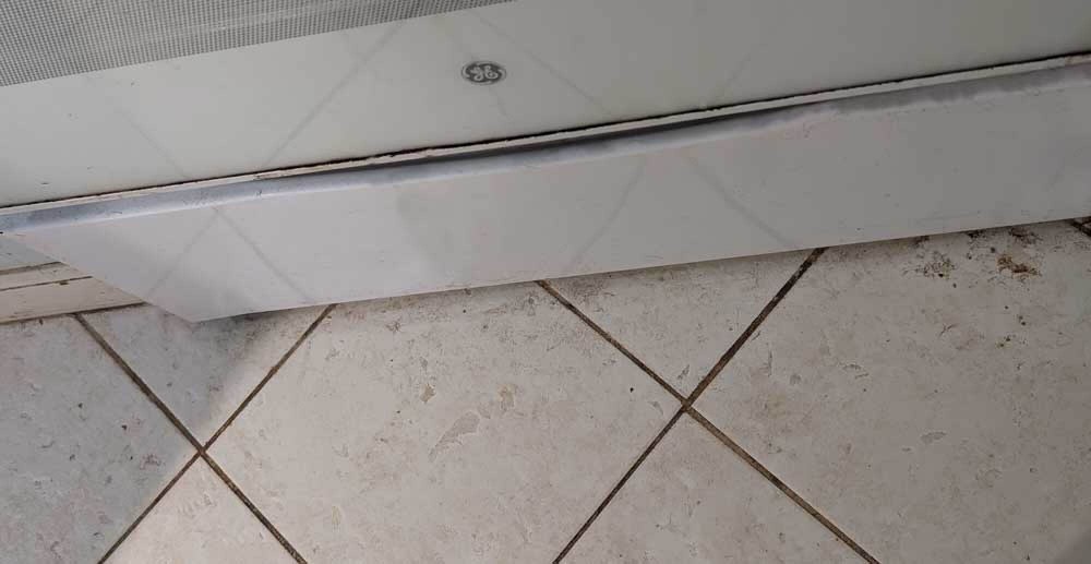 A band of unmopped floor next to oven