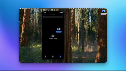 An iPhone mirroring window on the Mac, against a Mac home screen, showing the feature that lets you drag-and-drop files from an iPhone to a Mac and vice-versa.