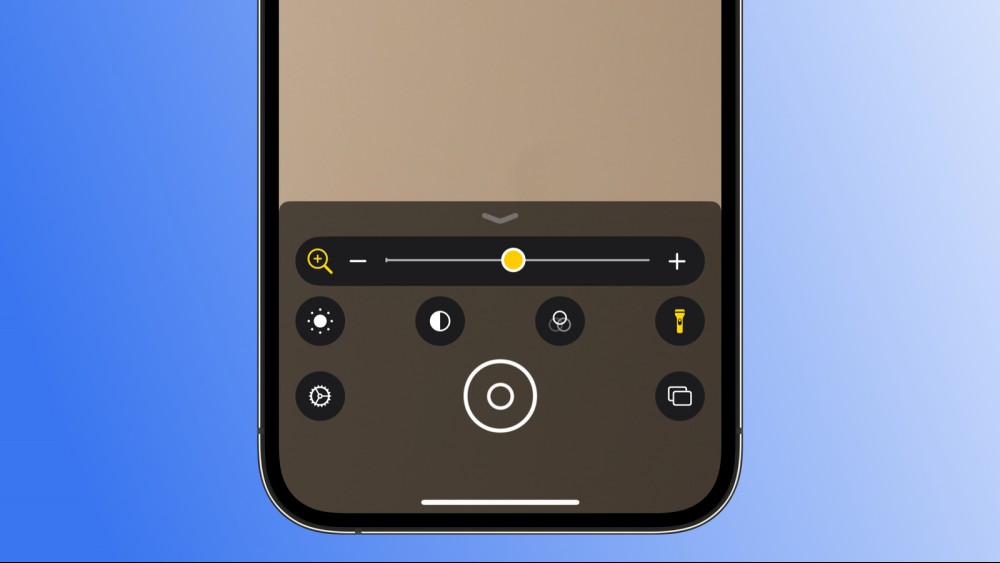 A screenshot of an iPhone against a blue gradient background, showing the Magnifier app.