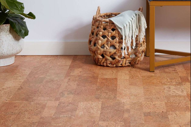 Brown cork flooring with wicker basket and houseplant 