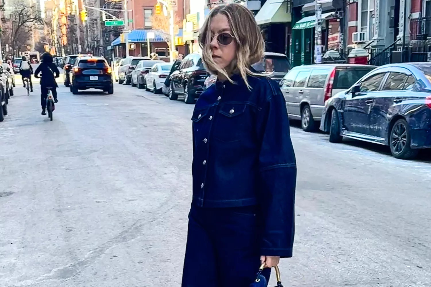 Woman wears Hoka Bondi 9 sneakers while walking on a city street