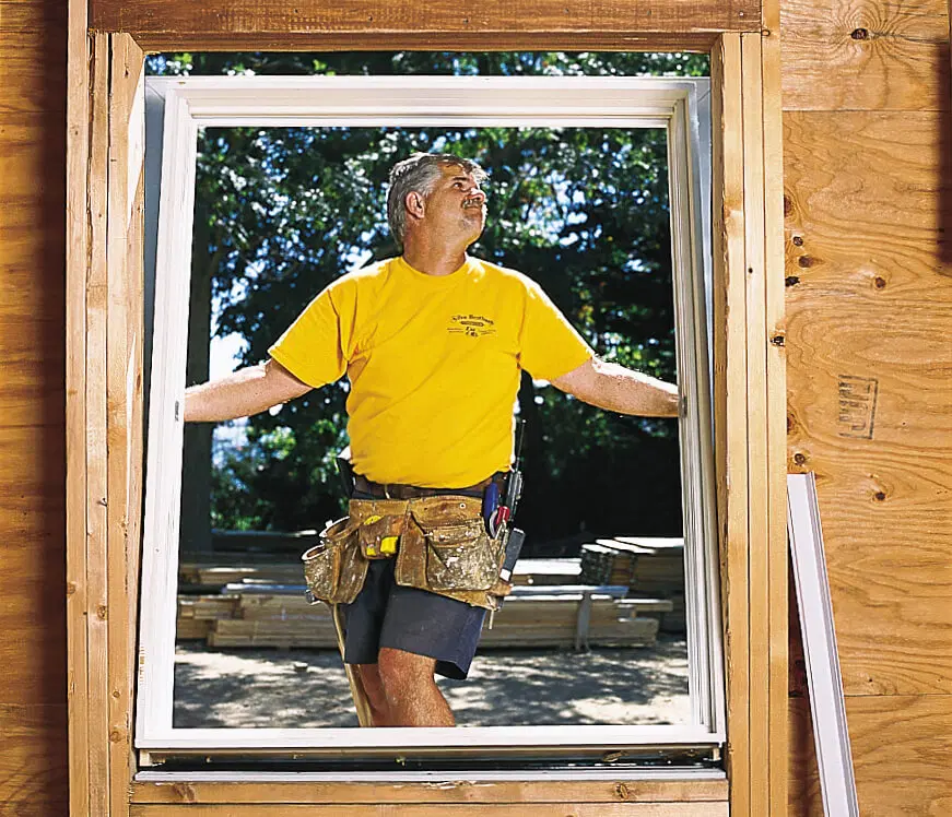 Man installing window