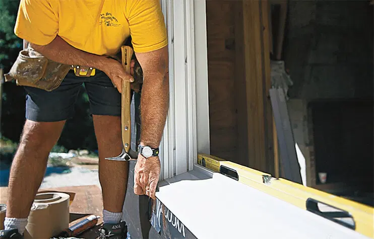hammering a window frame in place