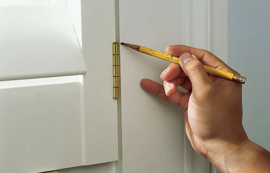 A pencil being used to mark where a shutter will be installed.
