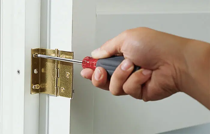 A screwdriver being used to install an internal shutter.