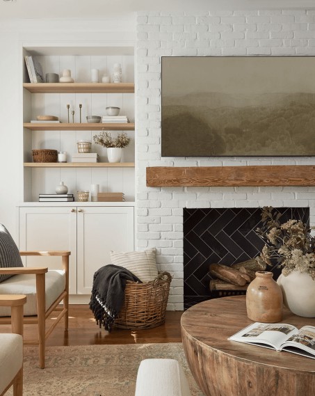 A living room with a woven basket filled with blankets and pillows