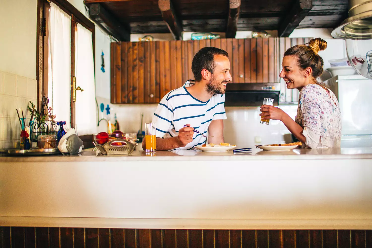 Loving couple in the kitchen eating breakfast