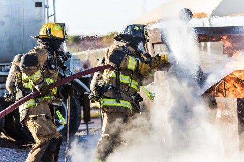 Firefighters spraying fire with water - Are gendered words like "mankind" sexist?