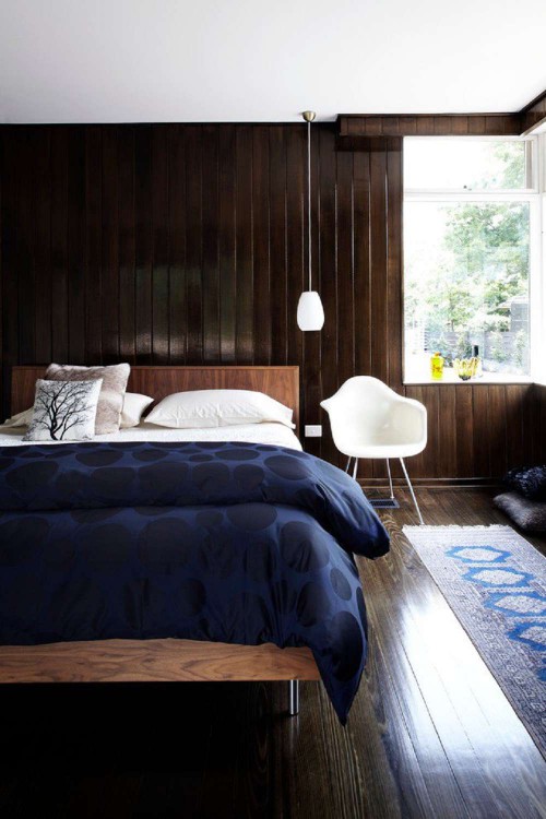 Dark wood walls in modern bedroom