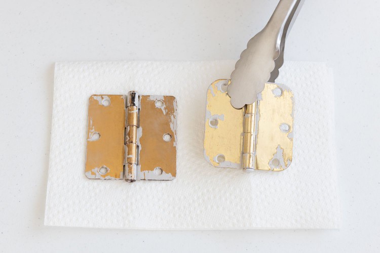 using tongs to place metal items on a towel