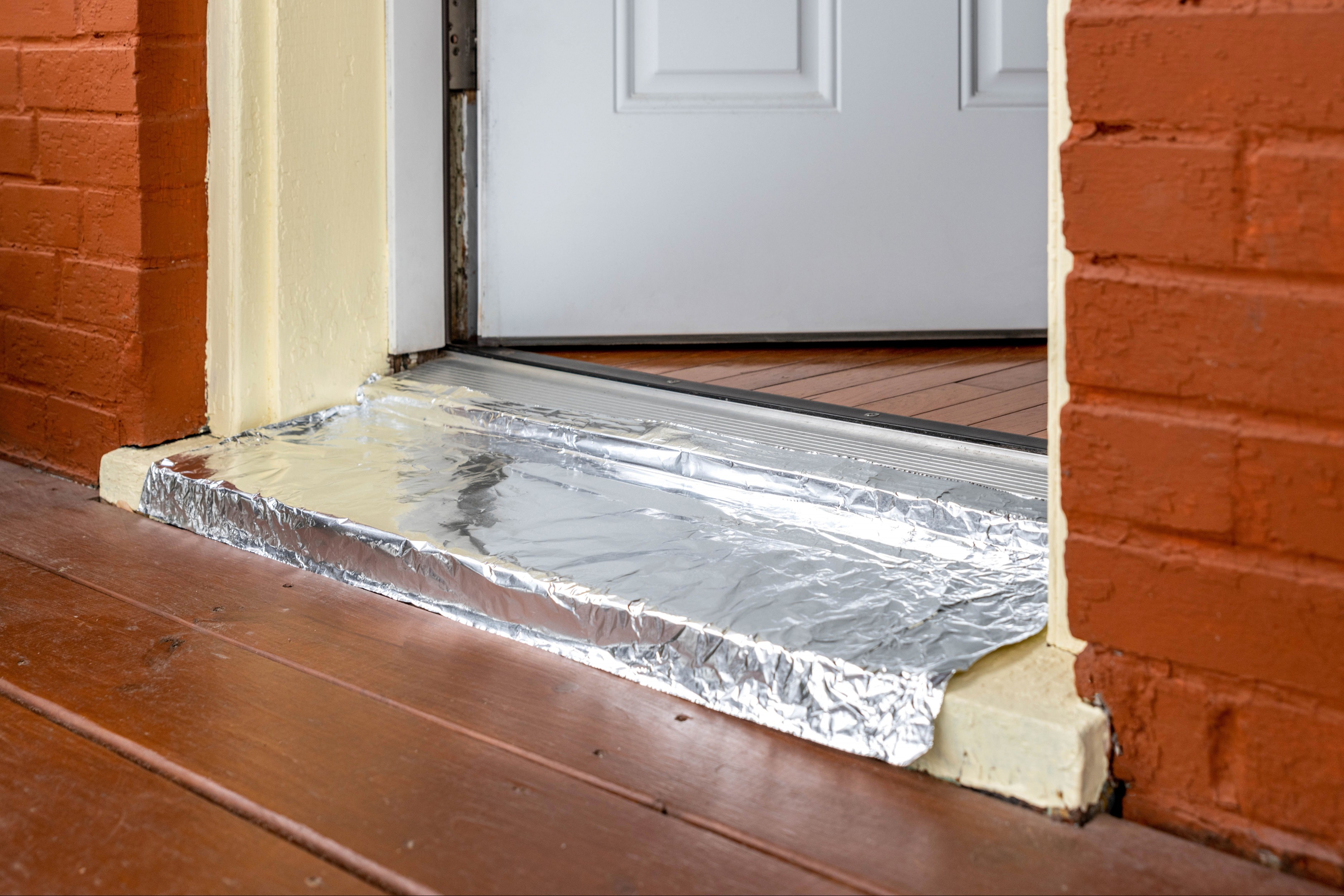 Front doorway covered in aluminum to prevent cats from escaping