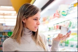 Woman at grocery store looking at yogurt