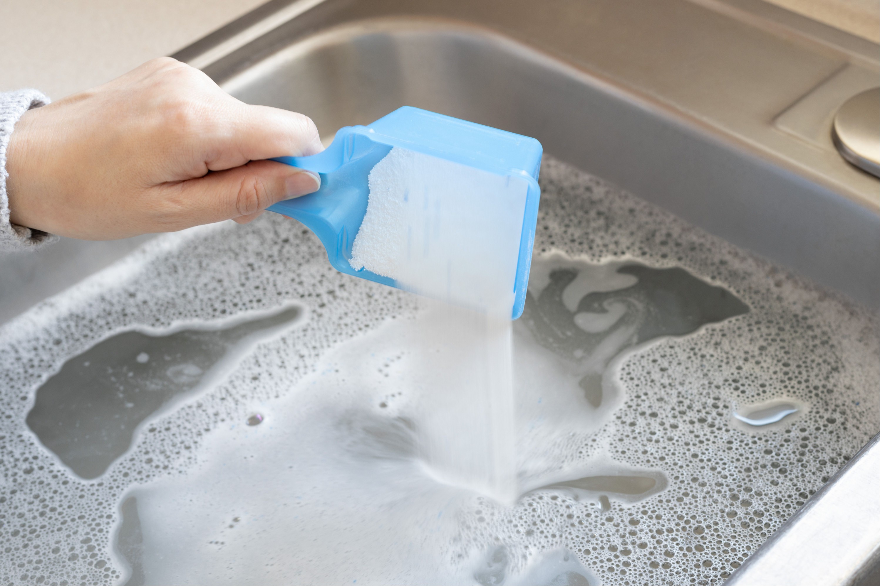 Sink filled with water and half-cup of oxygen bleach to remove cat urine odor