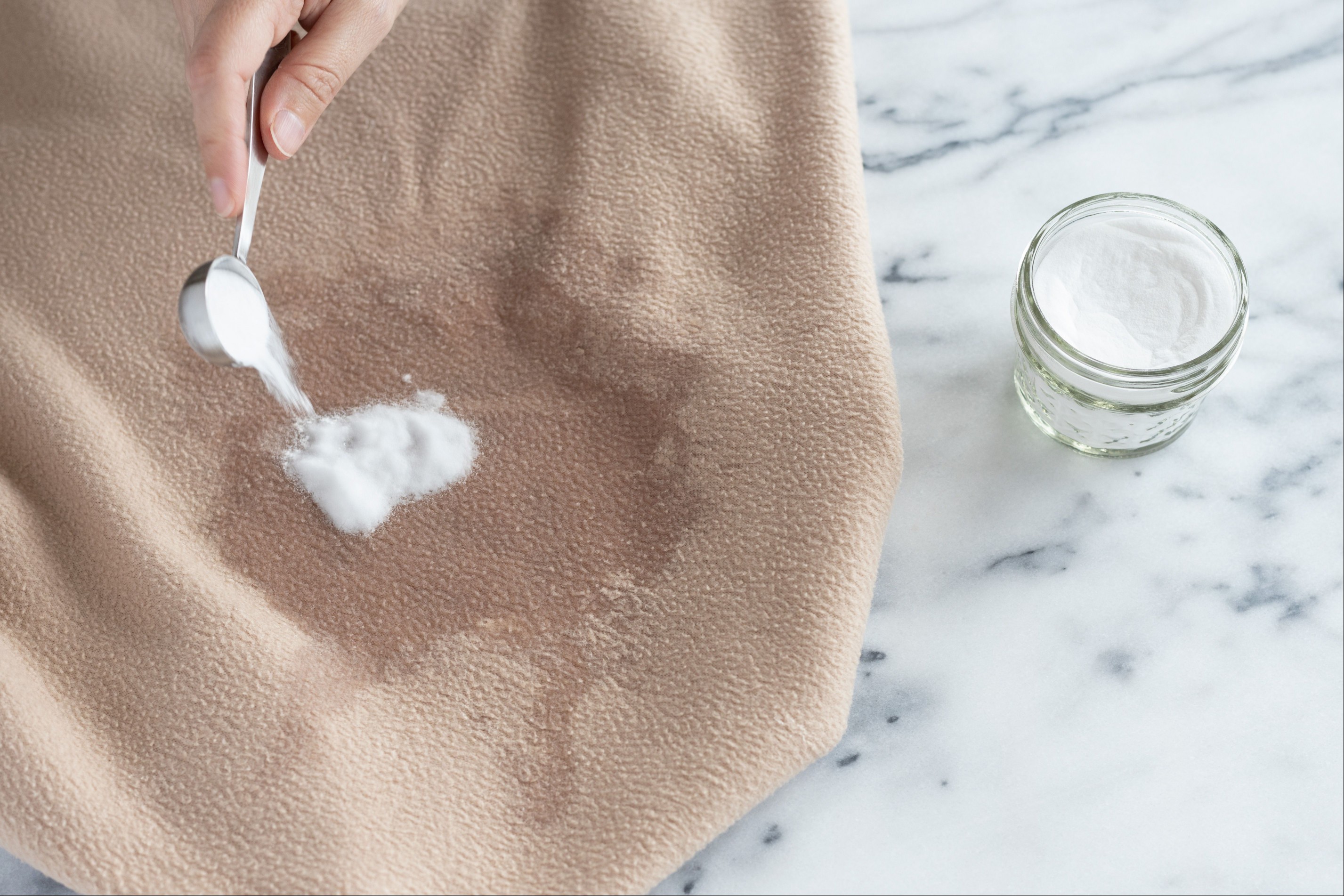 Baking soda poured on soaked area with cat urine on bedding