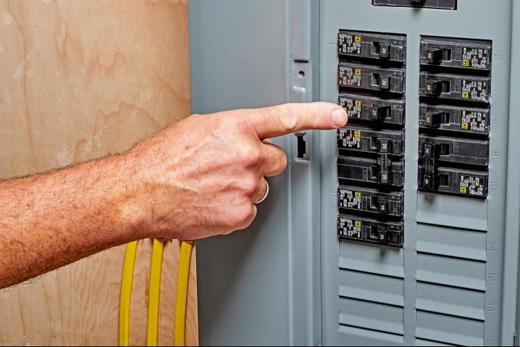 Finger pointing to tripped circuit breaker 